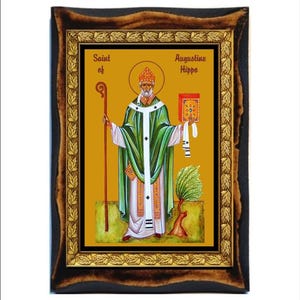 Op de afbeelding: Een ingelijst icoon van Sint Augustinus van Hippo. Het icoon is geschilderd in een traditionele stijl met gouden accenten. De heilige is afgebeeld in een groene robe en houdt een boek en een staf vast.