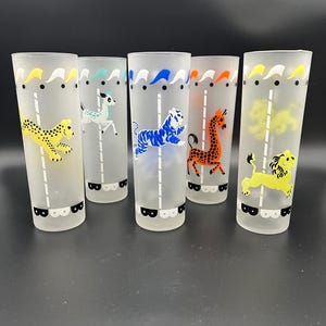 May include: A set of three ceramic mugs with a speckled, matte finish. Each mug features a different color: light blue, cream, and gray. The mugs have a simple, modern design with a rounded shape and a comfortable handle.