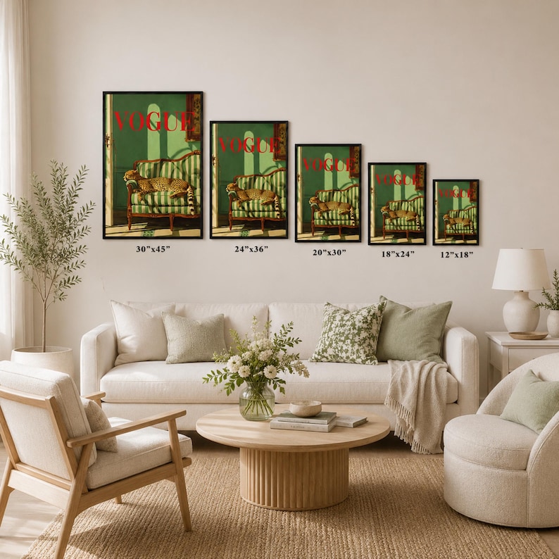 The image is a living room with a white sofa, a wooden coffee table, and a potted plant. There are five framed artworks of the same size and style displayed on the wall above the sofa, each depicting a different scene.