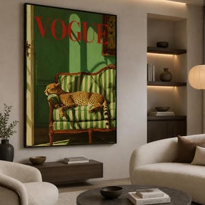 a large framed poster of a cheetah resting on a green and white striped sofa, with the word "Vogue" prominently displayed. The poster is hanging on a wall in a living room setting, with a sofa, chair, and coffee table visible in the background.