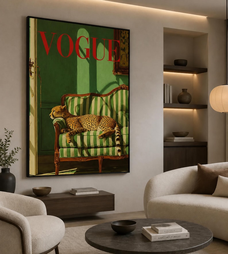 a large framed poster of a cheetah resting on a green and white striped sofa, with the word "Vogue" prominently displayed. The poster is hanging on a wall in a living room setting, with a sofa, chair, and coffee table visible in the background.