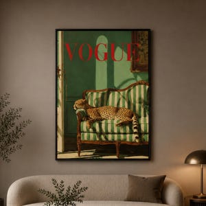 a living room with a large framed poster of a cat on the wall, a sofa, a coffee table, and a lamp.