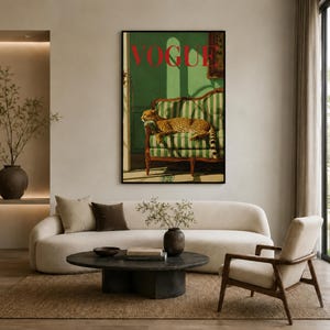 a living room with a large framed poster of a cheetah on the wall, a white sofa, a round coffee table, and a wooden chair.