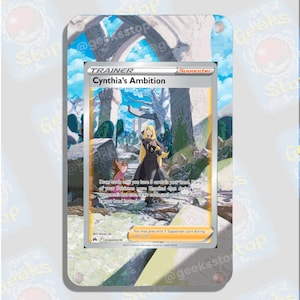 May include: A Pokemon trading card featuring Cynthia's Ambition, a Trainer Supporter card. The card has a blue and white background with a picture of Cynthia standing in a ruined city. The card text reads: "Draw cards until you have 5 cards in your hand. If any of your Pokemon were Knocked Out during your opponent's last turn, draw cards until you have 8 cards in your hand instead."