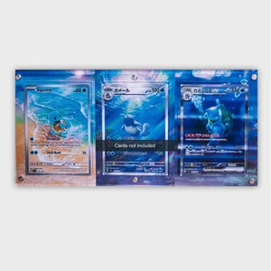May include: A rectangular acrylic display frame featuring three slots for trading cards, decorated with a blue water-themed graphic. The center of the frame displays a black rectangular label with the white text Cards not included.