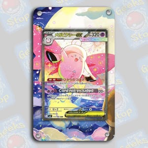 May include: A pink and white Pokemon card featuring a character with a hat and wings, set against a colorful background. The card is in a protective sleeve with a blue and pink design. Text on the card includes Japanese characters and "Card not included".