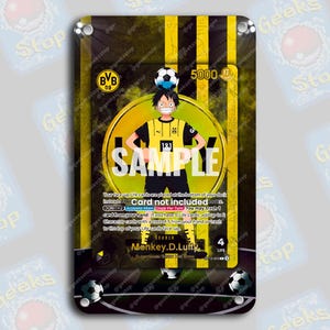 Peut inclure: Carte de collection avec un personnage de dessin animé en uniforme de football jaune et noir, un ballon de foot sur la tête. Le texte "SAMPLE" et "BVB 09" est visible. Le fond est à rayures jaunes et noires.