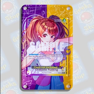 May include: A rectangular acrylic display case featuring a split purple and yellow background with white line art. Inside, a Charlotte Pudding trading card is visible, displaying anime-style character art, text, and game statistics.