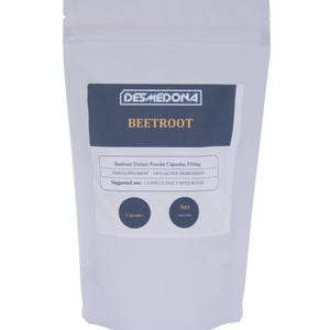 May include: A white pouch of beetroot extract powder capsules. The pouch has a dark blue label with the brand name "DESMEDONA" and the word "BEETROOT". The label also includes text about the product's ingredients and usage.