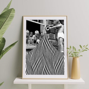 May include: Black and white photo of children looking out a window. A boy pours water from a watering can onto a black and white striped pattern.