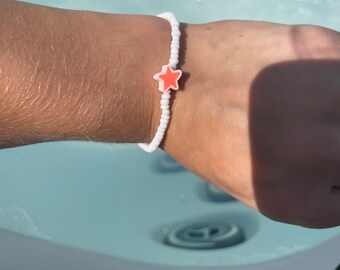 White seed beaded bracelet with a star in the middle