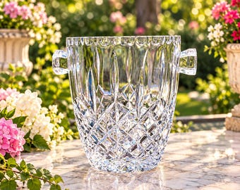 May include: A clear, heavy-duty crystal ice bucket featuring a multifaceted diamond-cut pattern on the lower body and vertical fluted carvings on the upper rim, complete with two sturdy, integrated crystal handles on opposite sides.