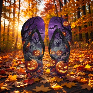 May include: A pair of Halloween-themed flip-flops. The purple background features jack-o'-lanterns, bats, and spooky trees. The straps are black. The flip-flops are resting on a bed of fallen autumn leaves.