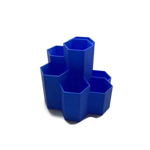 May include: A blue hexagonal desk organiser with six compartments. The organiser is made of plastic and has a modern design.