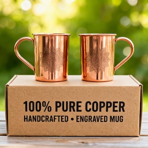 May include: A set of three ceramic mugs with a speckled, matte finish. The mugs are in shades of cream, light gray, and dark gray. Each mug has a simple, minimalist design, perfect for coffee or tea.