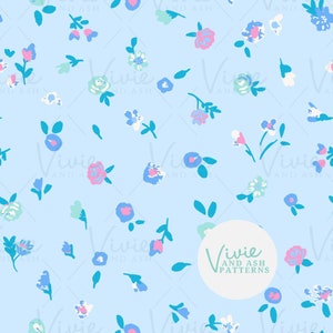 May include: A seamless pattern featuring a light blue background with a repeating design of small pink, blue, and white flowers with green leaves. The pattern is surrounded by a white circle with the text "Vivie and Ash Patterns" in green.