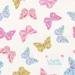 May include: A repeating pattern of butterflies in shades of pink, blue, and lime green on a cream background. The butterflies feature intricate wing details with colourful spots and lines. A circular logo with the text Vivie and Ash Patterns is visible.