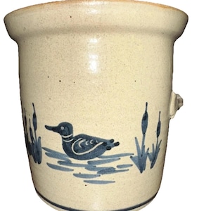 May include: A set of three ceramic mugs with a speckled, matte finish. Each mug features a different color: light blue, cream, and gray. The mugs have a simple, modern design and a comfortable handle.