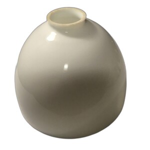 May include: A spherical white glass lamp shade with a smooth, glossy finish. The object features a circular opening at the top with a slightly thicker, rounded rim. The overall shape is bulbous and rounded, designed to diffuse light evenly.