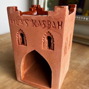 May include: A set of three ceramic mugs with a speckled, matte finish. The mugs are in shades of cream, light gray, and dark gray. Each mug has a simple, minimalist design, perfect for coffee or tea.