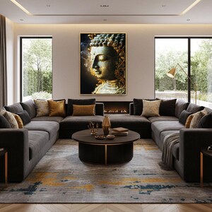 May include: A modern living room featuring a large gray sectional sofa, a round coffee table, and a patterned rug. A framed Buddha portrait hangs above a fireplace. Decorative pillows in gold and brown add color.