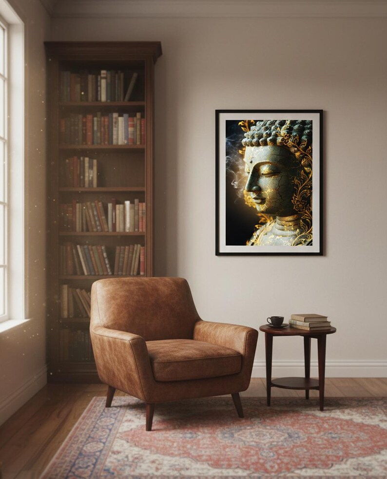 May include: A framed print of a serene Buddha statue. The artwork features a detailed depiction of the Buddha's face with gold accents and a dark background. The print is displayed in a room with a leather armchair, a bookshelf, and a patterned rug.