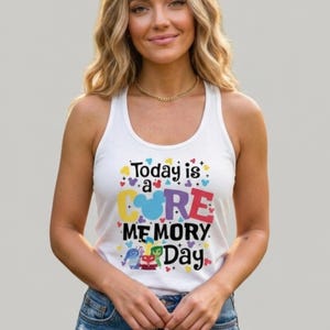 May include: White tank top with the text "Today is a Core Memory Day" in colorful letters. The design includes hearts and images of characters. The tank top is a casual, sleeveless garment.