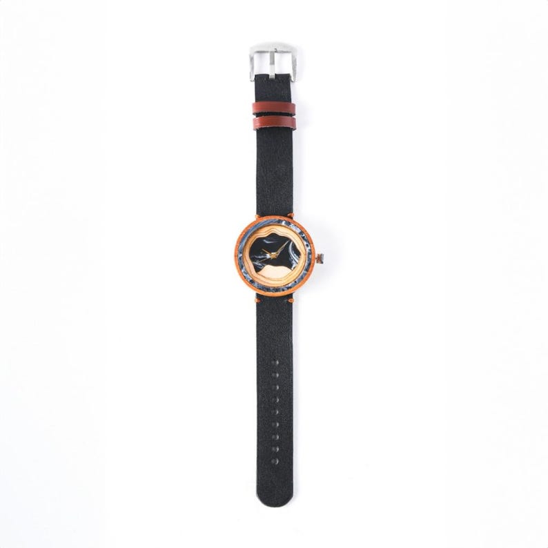 May include: A wooden wristwatch with a black face and a brown leather band.