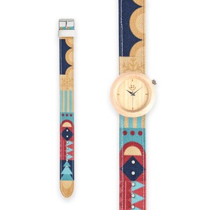 May include: A wooden wristwatch with a light wood face and a colorful geometric patterned canvas band. The band has red, blue, and yellow geometric shapes.