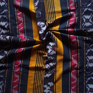 Traditional ikat pattern woven cotton yellow and red decor fabric with floral motif made by local artist from Indonesia