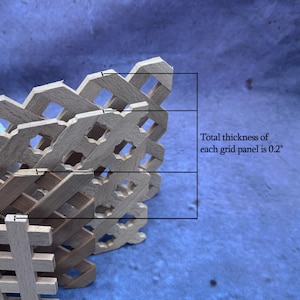 a close-up view of a wooden grid panel, with a text overlay indicating the total thickness of each grid panel is 0.2 inches.