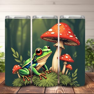 May include: A green tree frog with red eyes sits on a bed of moss next to a large red and white mushroom with white spots. Two smaller mushrooms are behind the large mushroom. The background is a dark green forest.