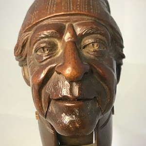 Nutcracker or hazelnuts in carved wood - character with a hat - popular art late 19th century - early 20th century
