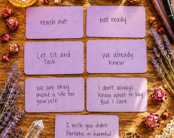 May include: Seven rectangular light purple cards with handwritten black text including phrases like reach out, not ready, Let sit and Talk, We already Knew, We are okay make a life for yourself, I don't always know what to say But I Care, and I wish you didn't Partake in harmful things.