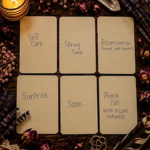 May include: Six rectangular cards with rounded corners arranged in two rows, each featuring handwritten text: Self Care, Spring Time, Reconciliation (friend, Lover anyone), Surprise, Soon..., and Phone Call With a Love interest on a dark wooden surface.