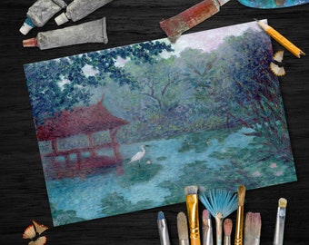 May include: A painting of a pond with a small red pagoda and a white bird on the water. The painting is surrounded by paintbrushes and tubes of paint on a dark wooden surface.