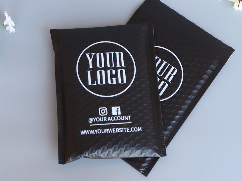 May include: Two black padded mailing envelopes with a white circle logo that says "YOUR LOGO" and the text "@YOUR ACCOUNT" and "WWW.YOURWEBSITE.COM".