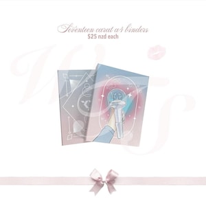 May include: Two A4 binders with pastel illustrations. One binder features a geometric design, the other a hand holding a light-up microphone. Text at the top reads "Seventeen carat a4 binders". A pink ribbon and bow are at the bottom.