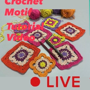 May include: A collection of colorful crochet motifs in various shapes and sizes, including squares and flower-like designs. The image also features balls of yarn in shades of pink, yellow, orange, and purple, along with crochet hooks. Text on the image reads "Crochet Motif Tutorial Video LIVE."
