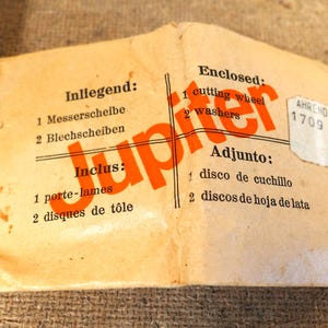 May include: Vintage package with the word "Jupiter" in orange. The package includes a cutting wheel and washers. Text in multiple languages indicates the contents.