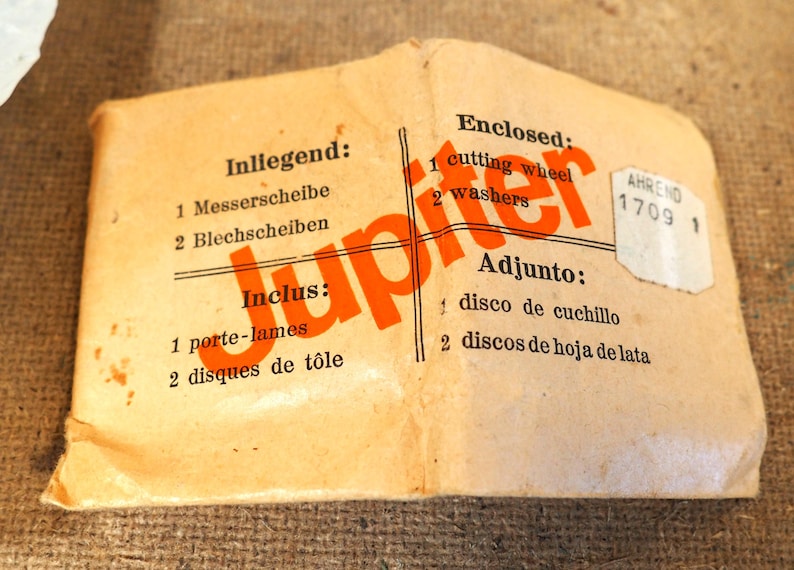 May include: Vintage package with the word "Jupiter" in orange. The package includes a cutting wheel and washers. Text in multiple languages indicates the contents.