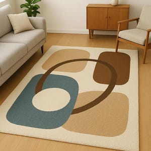 May include: A cream-colored area rug with a mid-century modern design. The rug features geometric shapes in shades of blue, brown, and tan. A brown oval shape and a white circle are also present. The rug is placed on a hardwood floor.