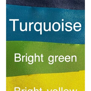 May include: A color palette featuring eight fabric swatches in a variety of colors. The colors include dark purple, light purple, navy, turquoise, bright green, bright yellow, orange, and pink. Each color is labeled with white text.