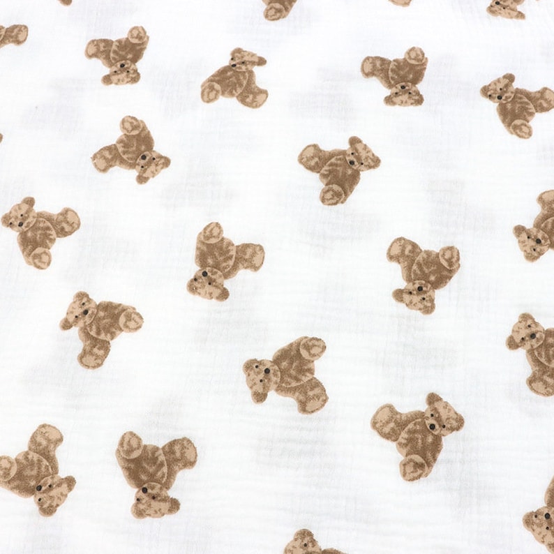 May include: White fabric with a repeating pattern of brown teddy bears.