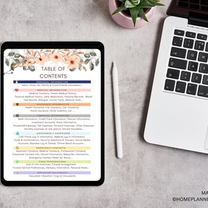 May include: A digital tablet displays a "Table of Contents" page with categories like "Personal Information" and "Medical Information." The tablet is next to a laptop and a white stylus. Floral accents decorate the top of the tablet screen.