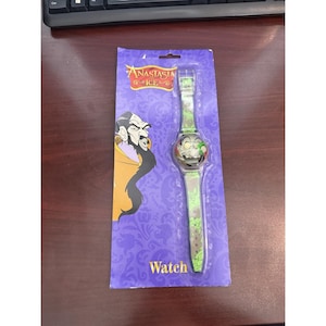 May include: A new Anastasia Ice watch on a purple card. The watch has a green and grey strap with a cartoon character on the face. The card has the words "Anastasia Ice" and "Watch" printed on it.