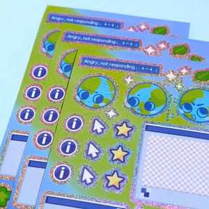 May include: A stack of stickers with a blue and green theme. The stickers feature a cartoon globe with a face, information icons, cursor icons, and stars. Text on the stickers reads "Angry, not responding". The stickers have a glittery border.