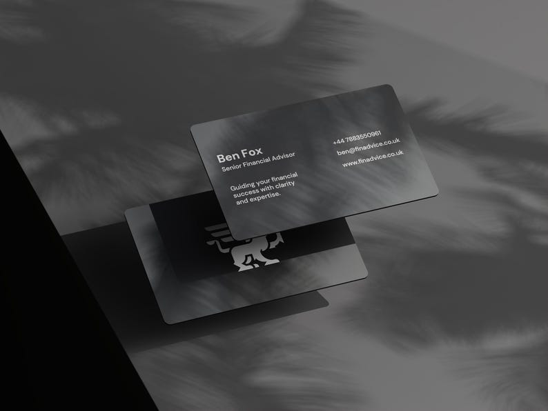 May include: Two dark grey business cards with rounded corners. The top card displays the name "Ben Fox, Senior Financial Advisor" and contact details. The bottom card features a logo. The cards are slightly overlapping, with shadows.