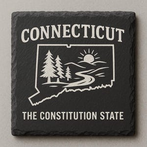 May include: A square, black slate coaster with the word "CONNECTICUT" at the top in white lettering. Below is a white outline of the state with a landscape scene inside. The words "THE CONSTITUTION STATE" are at the bottom.