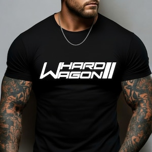 May include: Black crew neck t-shirt with the white text "HARD WAGON" in a bold, stylized font. The shirt has short sleeves and a classic fit. The design is centered on the chest.